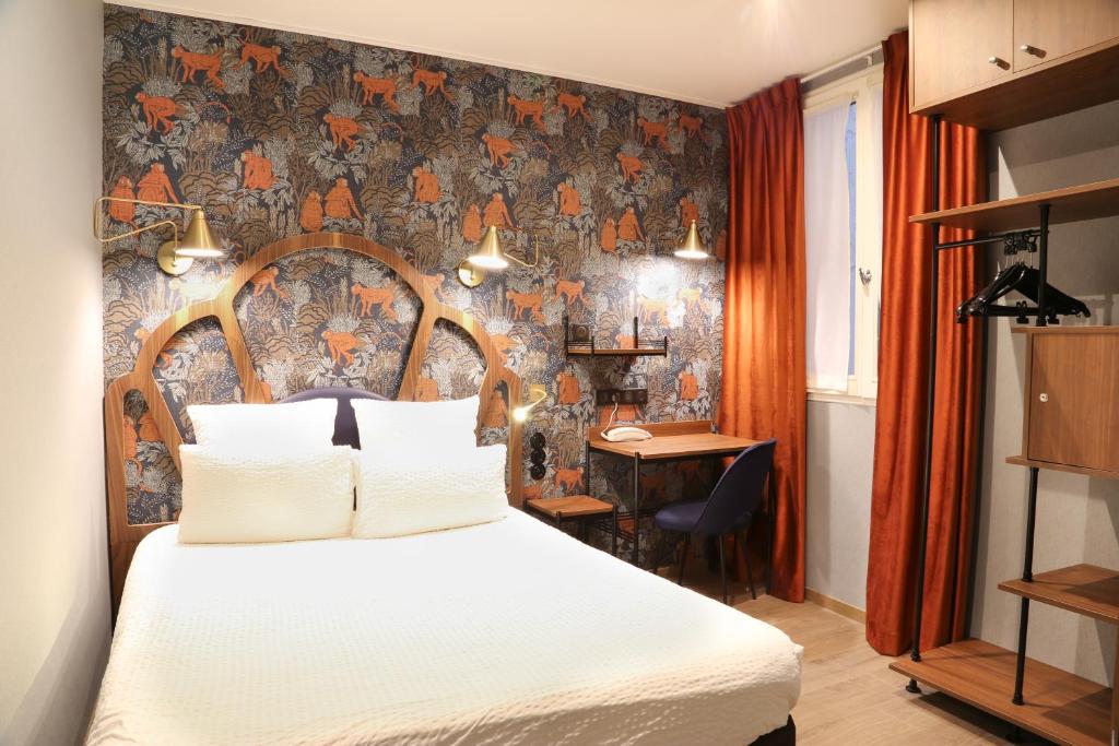 Hotel bedroom with a patterned feature wall, wooden headboard, and white bedding under warm wall lamps.
