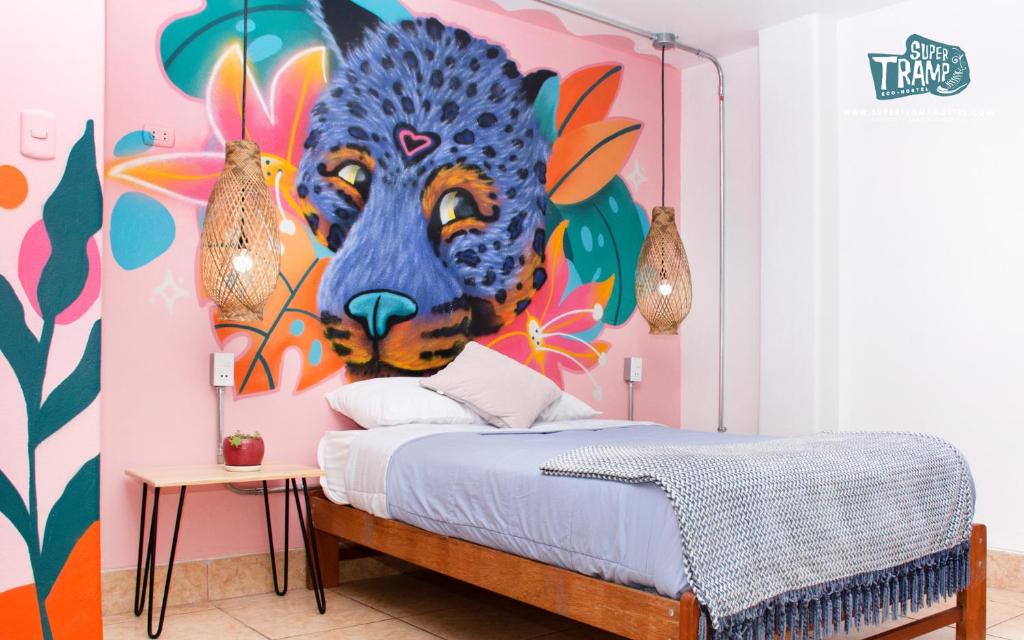 Bedroom featuring a blue leopard mural on pink wall above a wooden bed with light blue bedding and a small table with a plant.