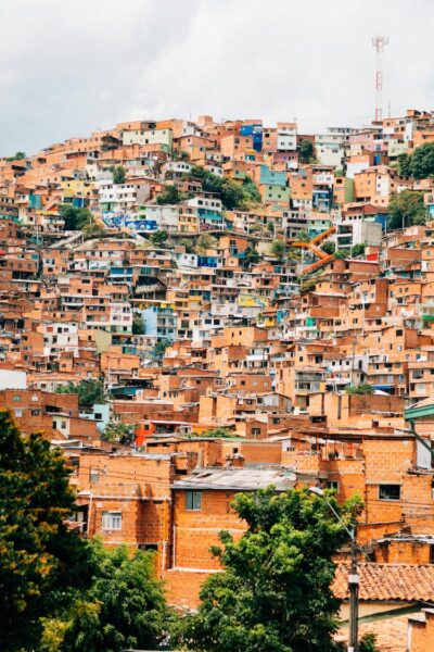 Colorful hillside neighborhood with densely packed houses on a steep slope (favela-like area).